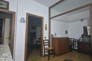 a living room with a mirror and a wooden dresser at Casa Vicolo ai Campi in Ardesio
