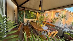 a balcony with a wooden table and potted plants at Villa Lujo y Relax in Adeje by Deihu Experiences in Adeje