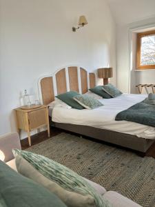 Łóżko lub łóżka w pokoju w obiekcie O'Cottage suite Familiale