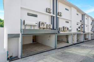 a large white building with a row of machines at Beach Walk Condo 3br in Replay residence in Bang Rak Beach