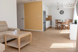 a living room with a couch and a table at Pine Tree House 9 D&D Apartments in Międzywodzie +8 photos