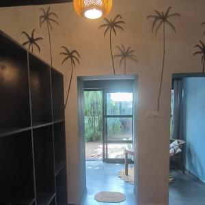 a room with palm trees on the wall at Mad about Coco Yoga & Beach Retreat in Varkala