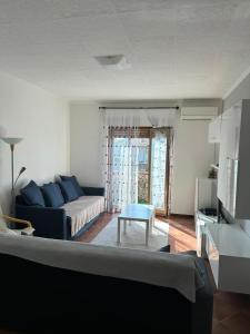 a living room with a couch and a table at Appartamento Aris in Monfalcone +9 photos