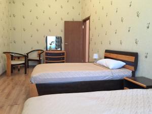 A bed or beds in a room at Tsolmon's Serviced Apartments