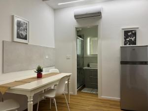 a kitchen and dining room with a table and a refrigerator at Dreaming Ortona in Ortona