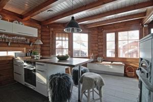 a kitchen with a table and some chairs in it at Villa Sol Tahko in Tahkovuori