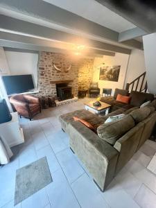 a living room with a couch and a fireplace at Gite Les Petits Dragons in Carnoët