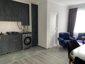 a living room with a washing machine and a kitchen at Отдых в Ташире in Vorontsovka
