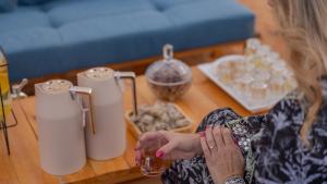 a woman sitting at a table with a glass of wine at Infinity Camp in Bidiyah