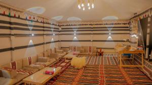 a living room with couches and a rug at Infinity Camp in Bidiyah