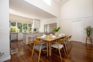 a kitchen and dining room with a wooden table and chairs at The Avenue in Anglesea
