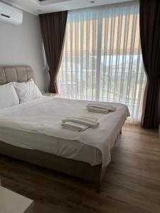 a bedroom with a bed with two towels on it at Vacation home with private pool, Fethiye, Oludeniz in Cedit +35 photos