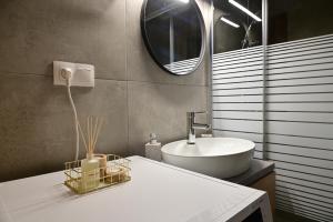 a bathroom with a sink and a mirror at Valia's Elegance Stays in Alexandroupoli +24 photos