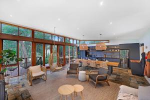 a living room with a lot of windows at Kurraburra Lodge in Anglesea