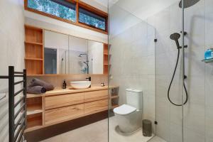 a bathroom with a toilet and a sink and a shower at Kurraburra Lodge in Anglesea +22 photos