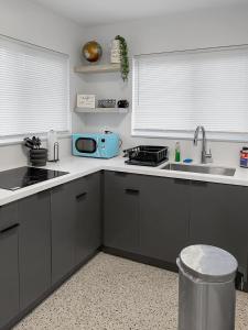 a kitchen with a sink and a microwave at Newly Remodeled full Apartment in Miami