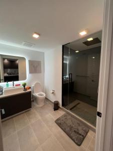 a bathroom with a shower and a toilet and a sink at Ocean View Entire Condo In Downtown With Pool and Gym in Miami