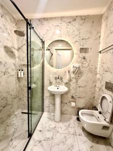 a bathroom with a sink and a shower and a toilet at Hotel Wine Time Tbilisi in Tbilisi City +40 photos