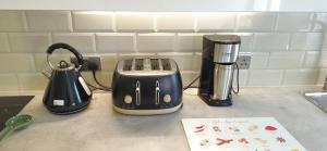 a toaster sitting on top of a kitchen counter at MPL Ensuites with kitchenettes Suites - Leeds City - Netflix & WIFI- First Direct & 02 Arena- LGI Hospital & Uni 5 Mins in Leeds