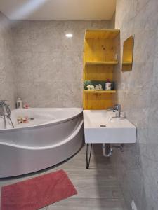 a bathroom with a white tub and a sink at Just Room Rent AKH University in Vienna