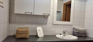 a white bathroom with a sink and a mirror at Miiluranta Villas in Haapamäki +122 photos