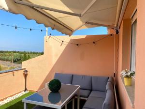 a patio with a couch and a table at Duplex Torre la Sal Magic World La Tormesilla in La Estación