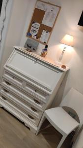 a white dresser with a lamp and a white chair at Brezza Marina in Isola delle Femmine +34 photos