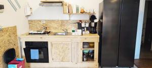 a kitchen with a sink and a refrigerator at Residenza BiblioSosta in Ventimiglia