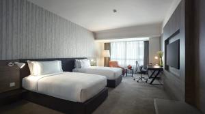 En eller flere senger på et rom på G Hotel Gurney
