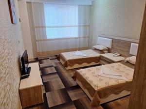 Postel nebo postele na pokoji v ubytování Arena Hotel Khachmaz