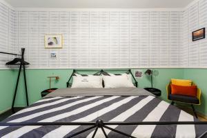 a bedroom with a bed and a chair at Chengdu city center Tianfu Square Kuanzhai Alley People's Park subway post-modern design 85 square meters 2 bedrooms 1 living room design B&B HD cinema family suite in Chengdu