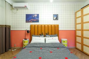 a bedroom with a bed with red hearts on it at Chengdu city center Tianfu Square Kuanzhai Alley People's Park subway post-modern design 85 square meters 2 bedrooms 1 living room design B&B HD cinema family suite in Chengdu