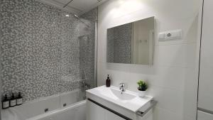 a white bathroom with a sink and a shower at Vinalopó apartment con parking in Elche +11 photos