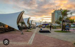 een straat met tafels en banken in een stad bij Apartamento na Pituba in Salvador