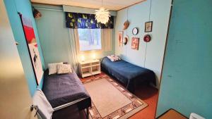 a small room with two beds and a window at Authentic Countryhouse at the Reindeer Farm in Tanhua