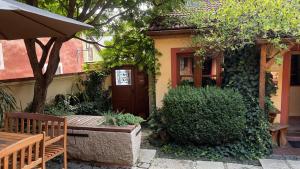 a house with a table and a bench in front of it at Hostel Postel in Český Krumlov