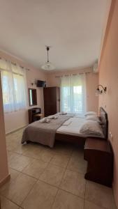 a bedroom with a large bed in a room at Tsipos Rooms in Stavros