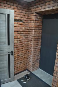 a room with a brick wall and a door at 1комн лофт в центре in Semey