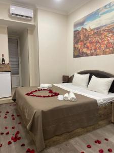 a bedroom with a bed with roses on it at Sweet Rooms Inn in Tbilisi City
