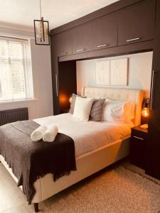 a bedroom with a large bed with a large headboard at The Secret Garden Retreat With Hot Tub in Manchester