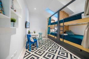 a bedroom with a bunk bed and a table at Hostel Sokol Centar in Osijek