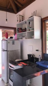 a kitchen with a sink and a refrigerator at Casa #2 - Piscina a 400 mts da Praia, 2 suites com Ar Cond - Taipu de Fora, Barra Grande in Marau