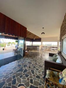 a living room with a stone floor and a couch at Pousada Fazendinha Beach Club Arraial do Cabo in Arraial do Cabo