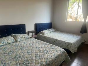 Postel nebo postele na pokoji v ubytování Quinta Las Mendoza