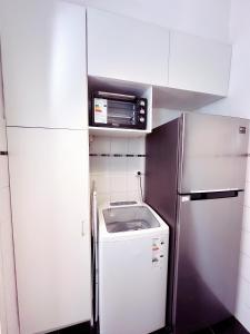 a small kitchen with a refrigerator and a microwave at Amplio monoambiente en Microcentro in Buenos Aires