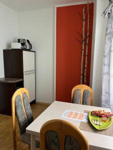a dining room with a table and two chairs at Marktblick in Radeburg +5 photos