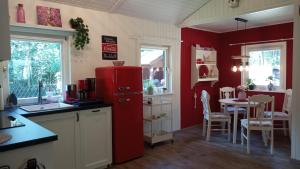 a kitchen with a red refrigerator and a table at Ferienhaus Bea in Buchholz Aller