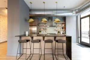 a kitchen with a large counter with stools at Loop 1BR wGym Roofdeck WD nr W Loop the L CHI-200 in Chicago