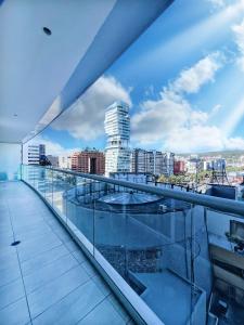 a view of a city from the balcony of a building at Amplio Departamento en el edificio ONE , Frente a La Carolina in Quito