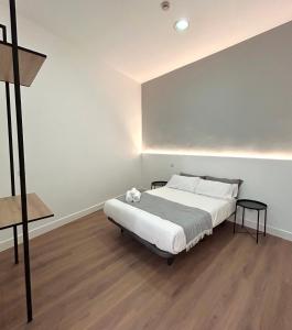 a bedroom with a large bed in a room at H21 Rooms in Madrid +7 photos